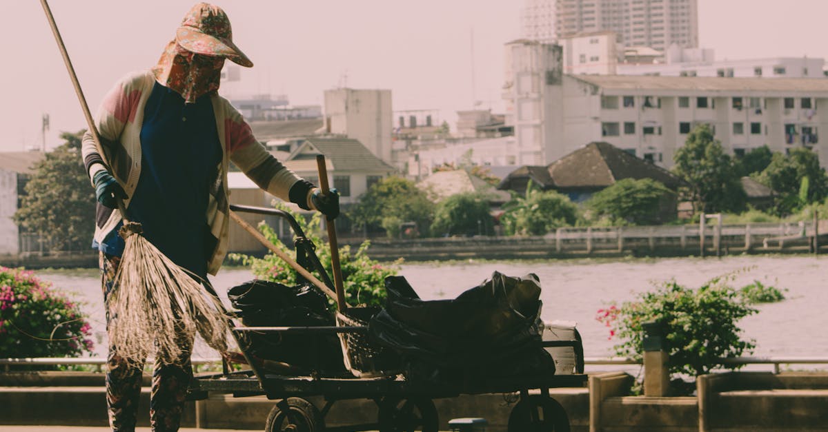 A hardworking woman cleaning the riverside in Bangkok, Thailand.